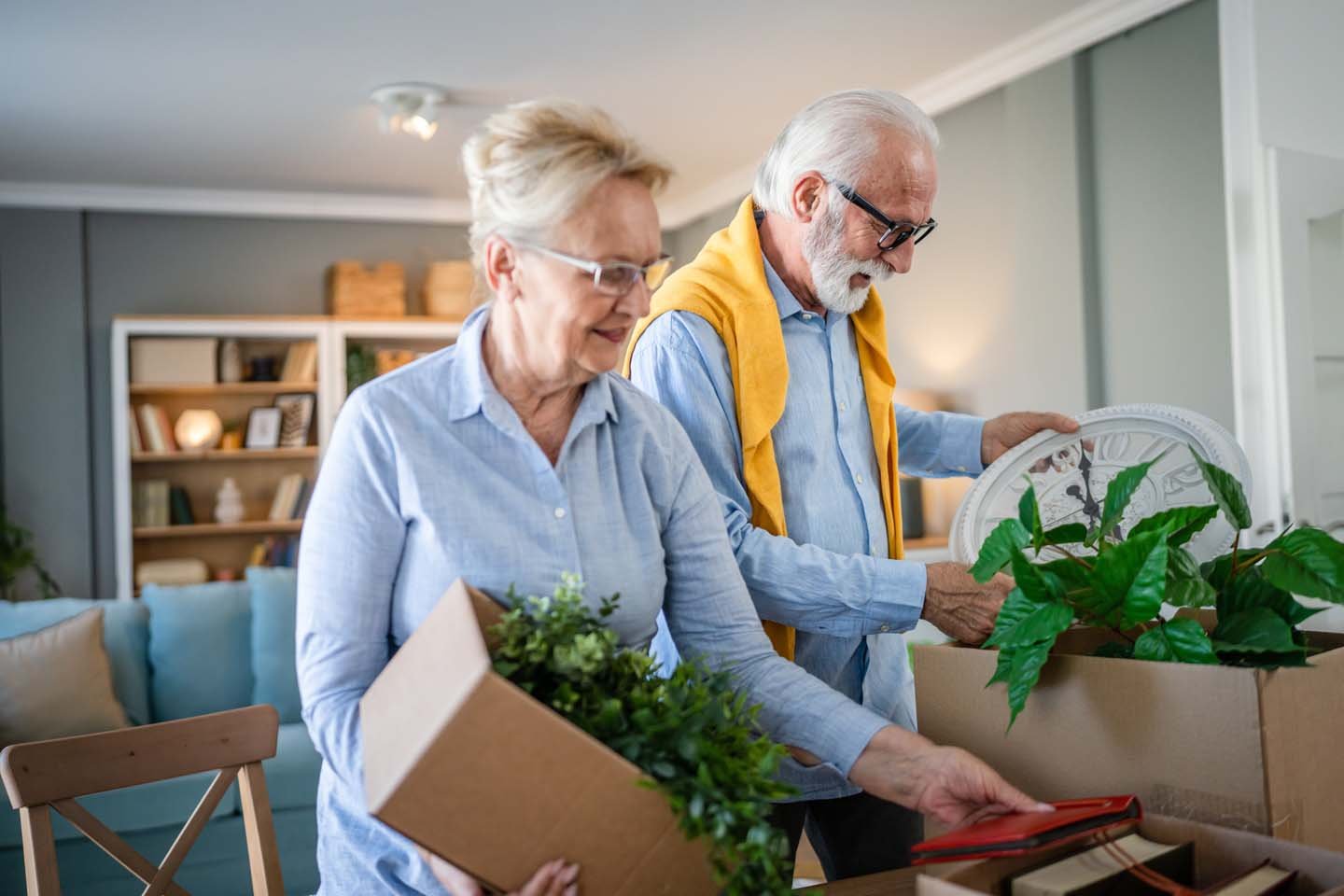Senior couple packing to downsize