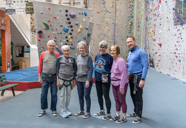 Residents at a rock climbing facility through the Immanuel Adventures program