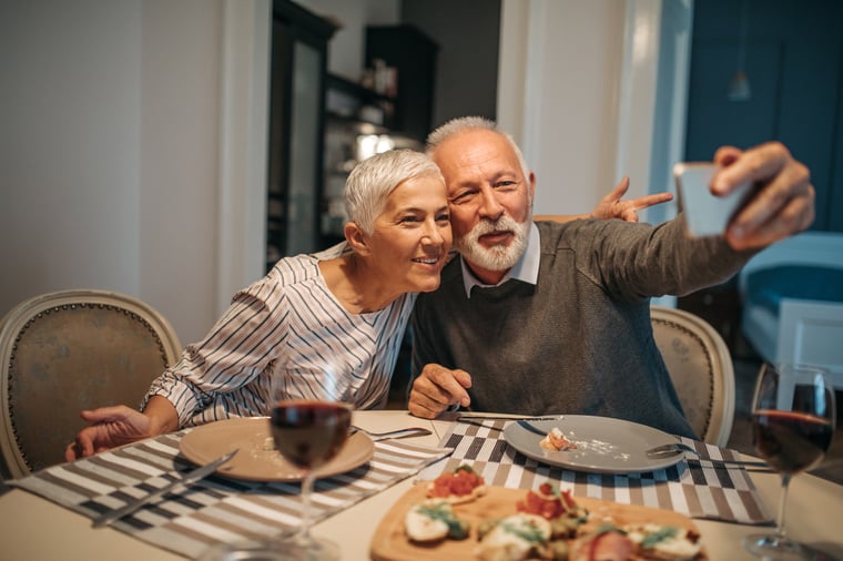 elderly couple taking photo together