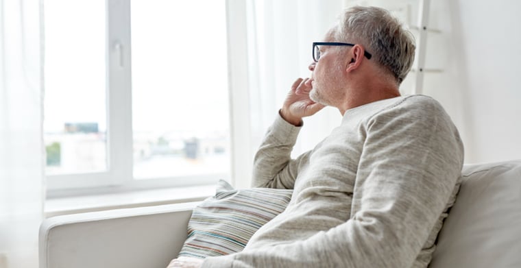 man looking out window