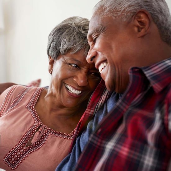 Senior couple hugging and laughing.