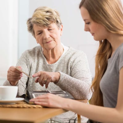 Senior woman and adult woman looking at photos