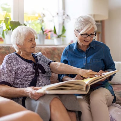 Senior women looking at photo album.