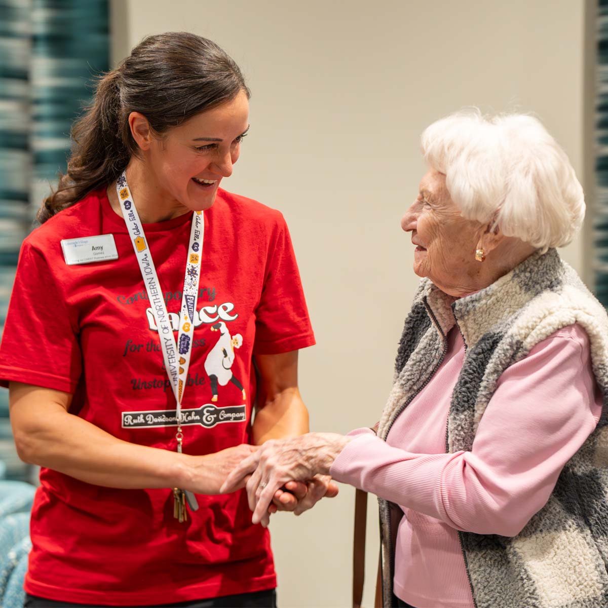 A Lakeside team member helps a resident during a dance class.