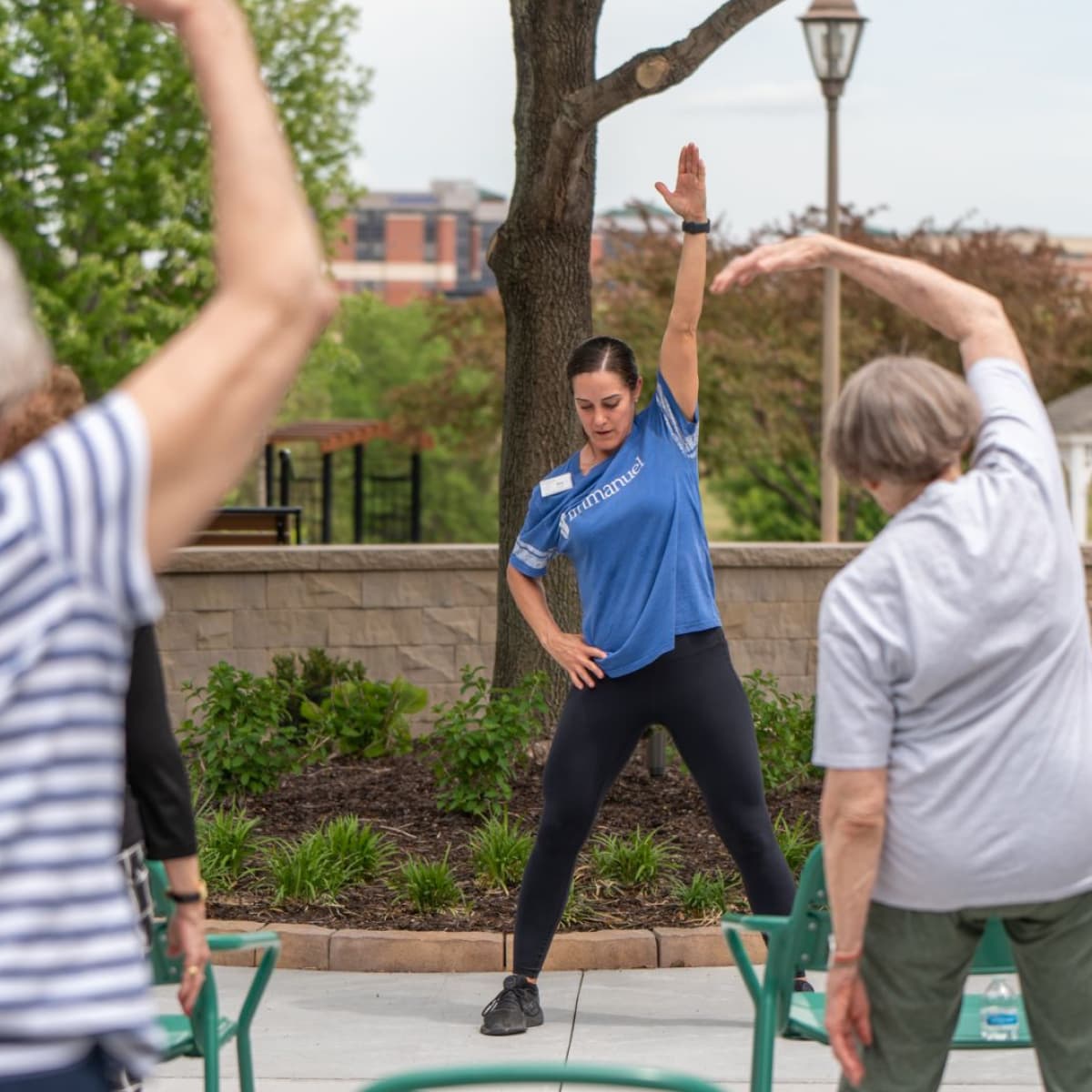 A wellness instructor leads an exercise class of seniors.