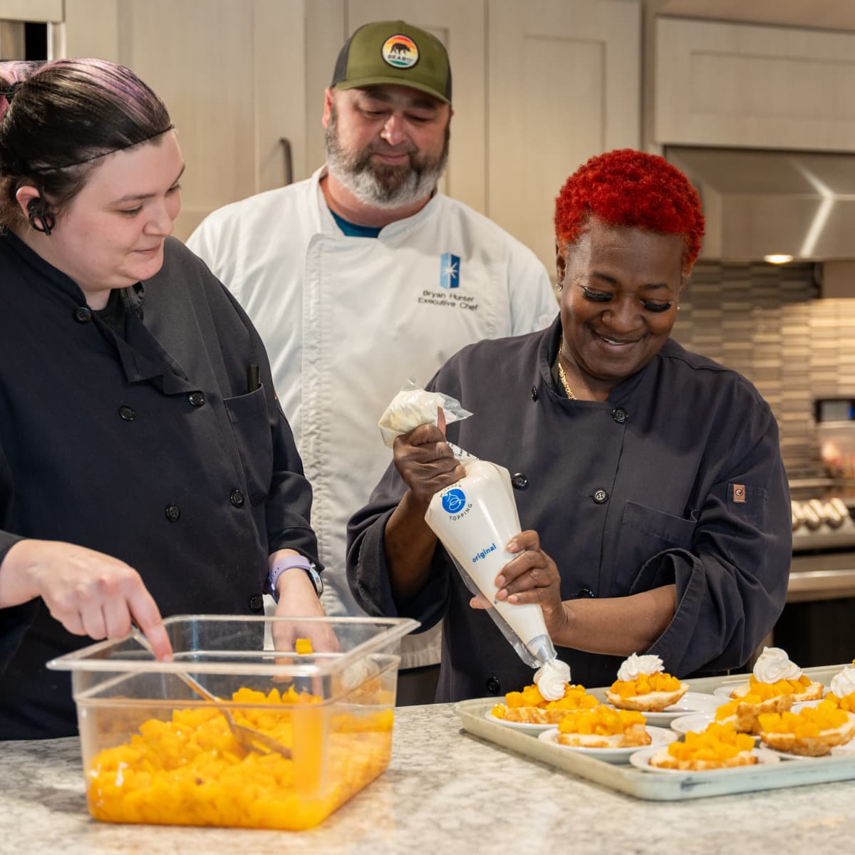 A group of Immanuel culinary team members prepare desserts.