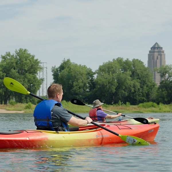 An Immanuel employee kayaks on a lake with a resident.