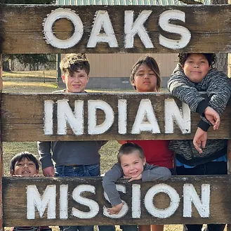 Oaks Indian Mission sign with kids.