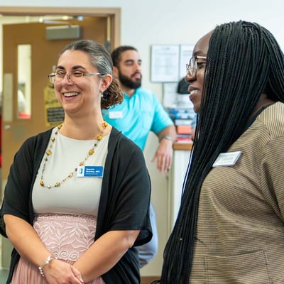 Immanuel Pathways employees talk during an event at the center.