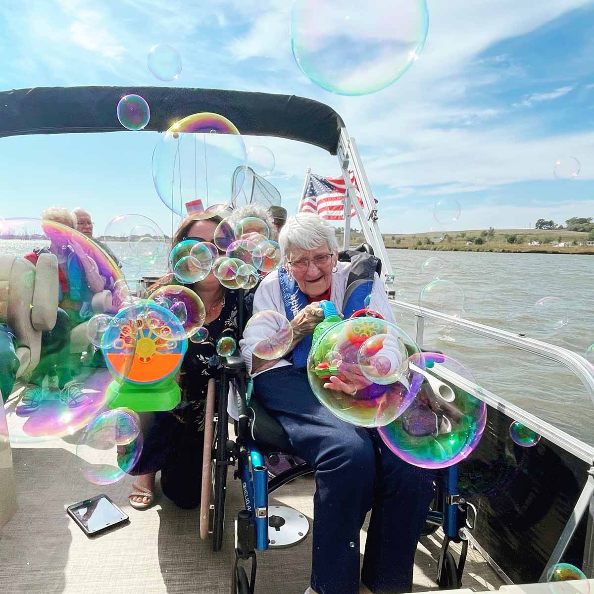 A group of seniors are on a recreational therapy boat outing.