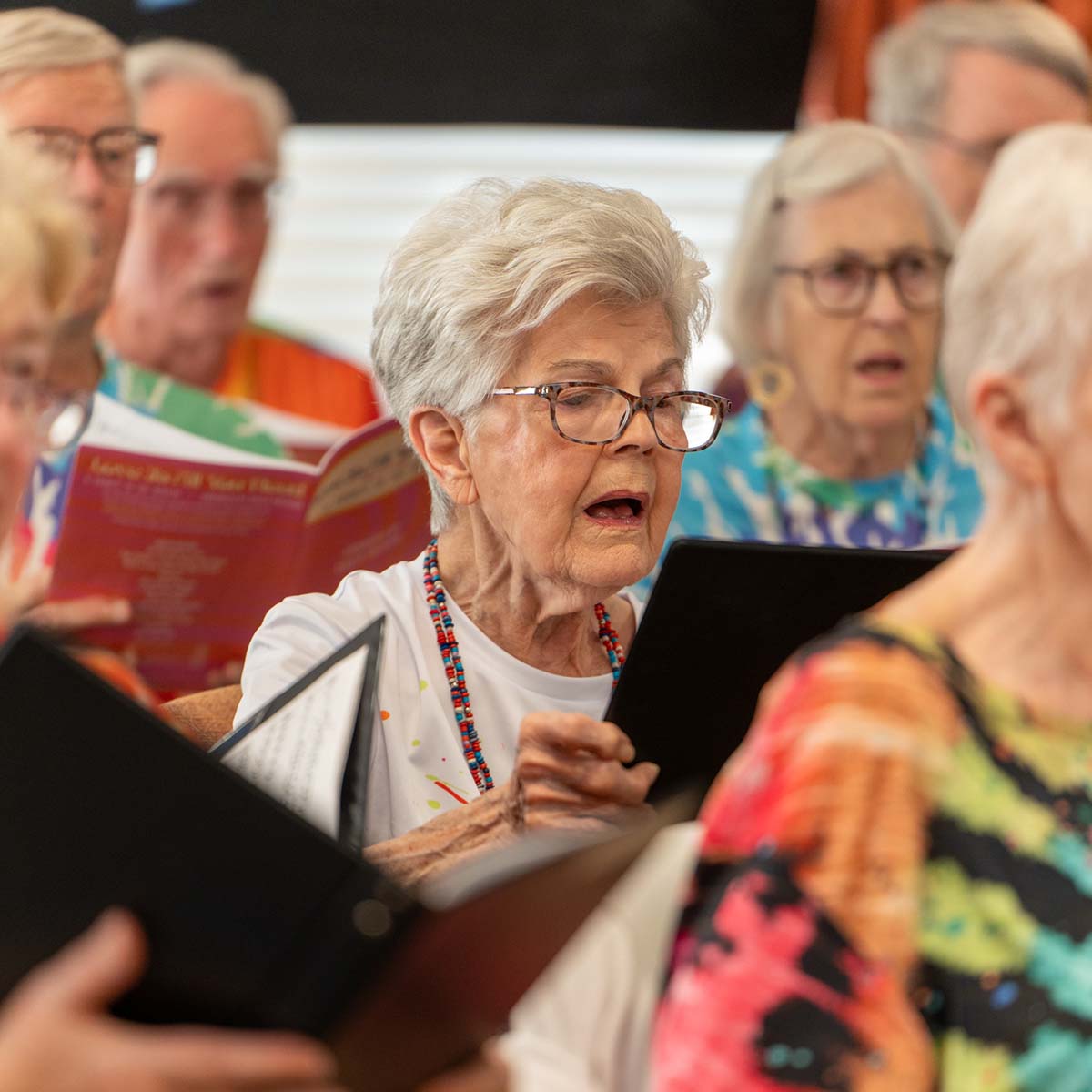 Several residents sing while looking at sheet music in the Immanuel choir.