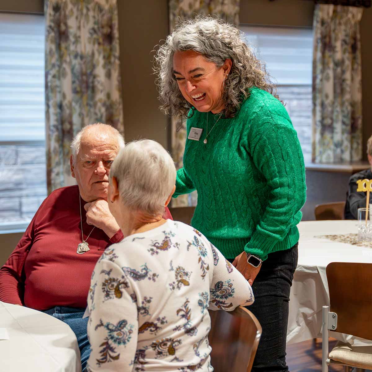 An Immanuel retirement  living consultant talks with residents sitting at a table.