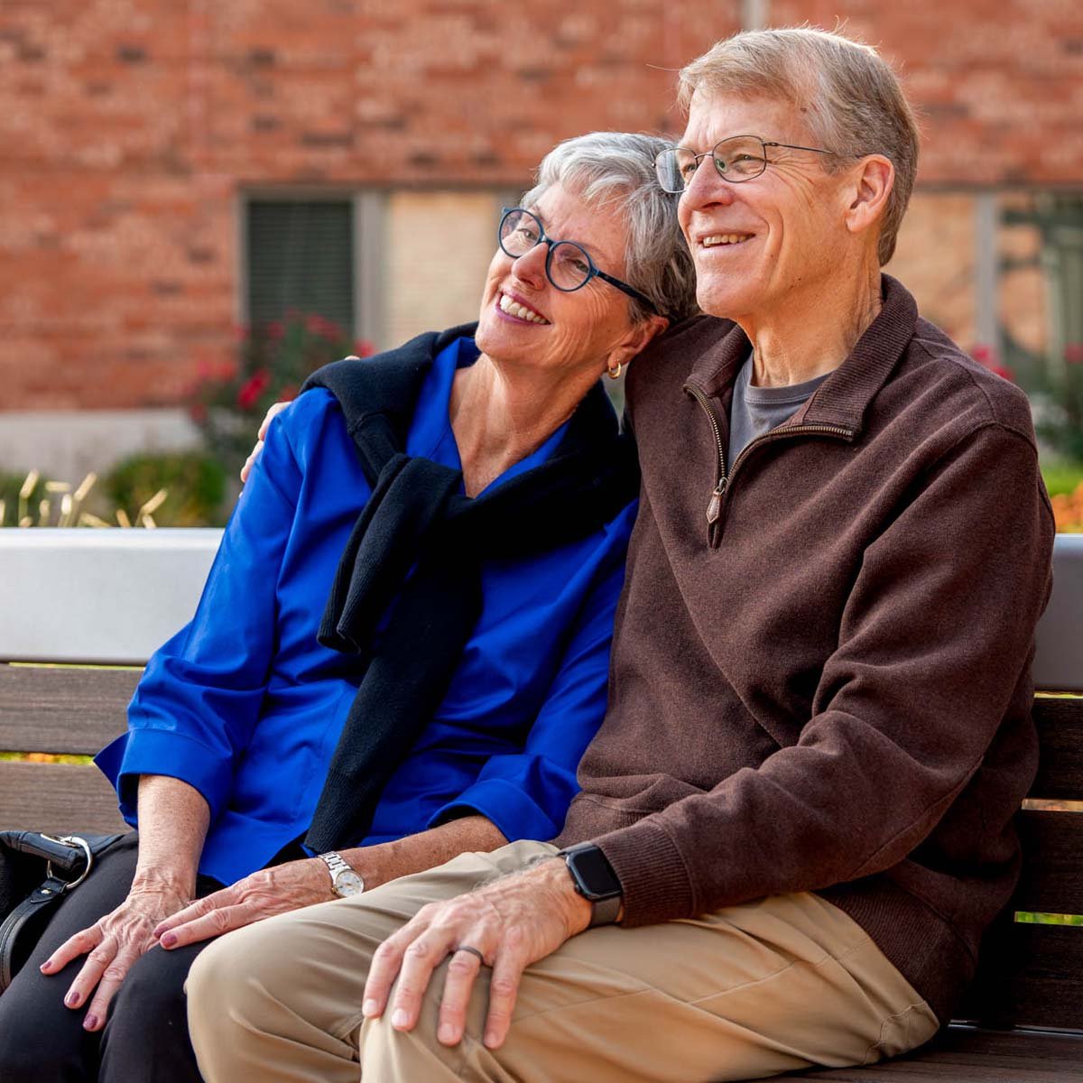 senior-couple-sitting-on-a-bench-1200x1200
