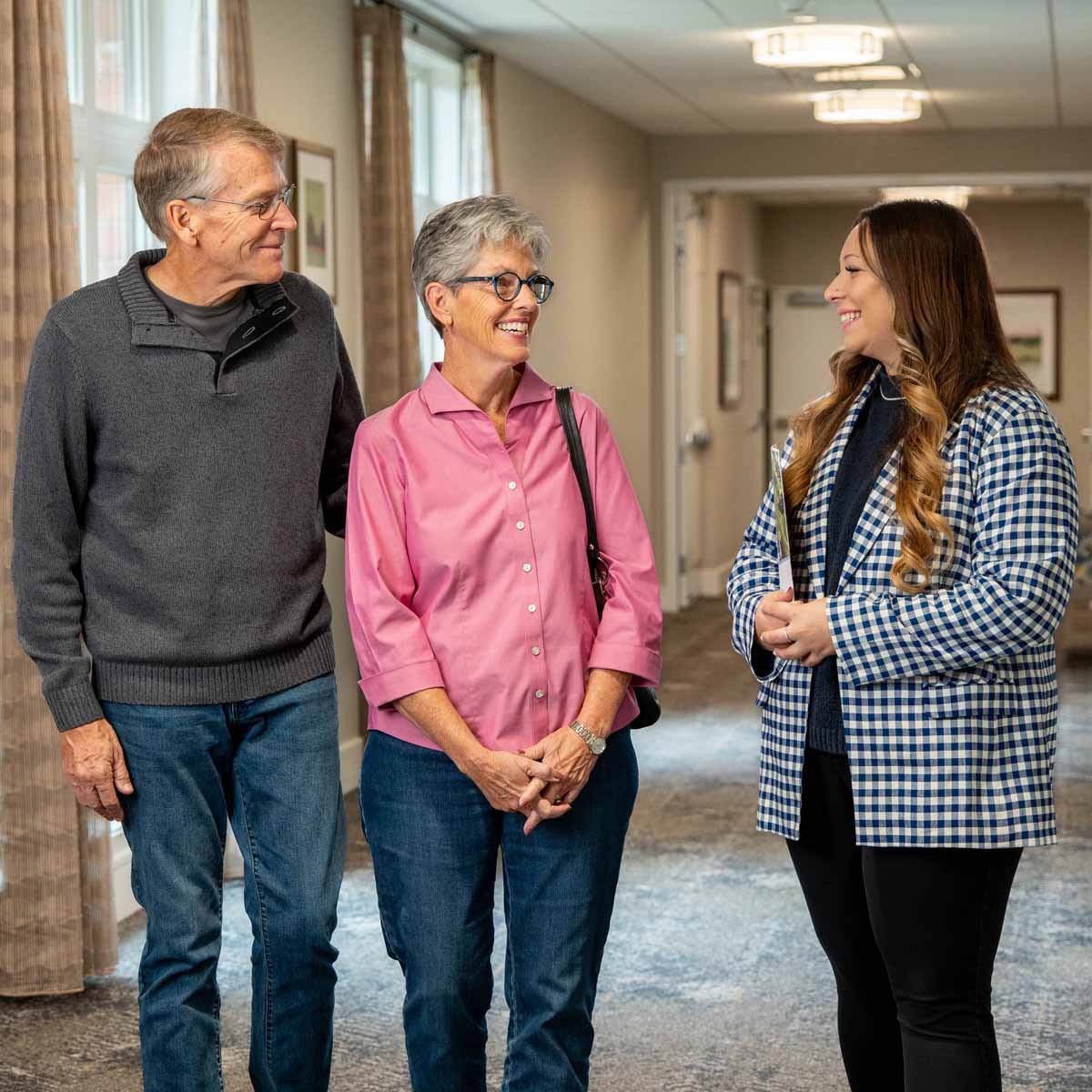 Senior couple talks with a retirement living consultant.