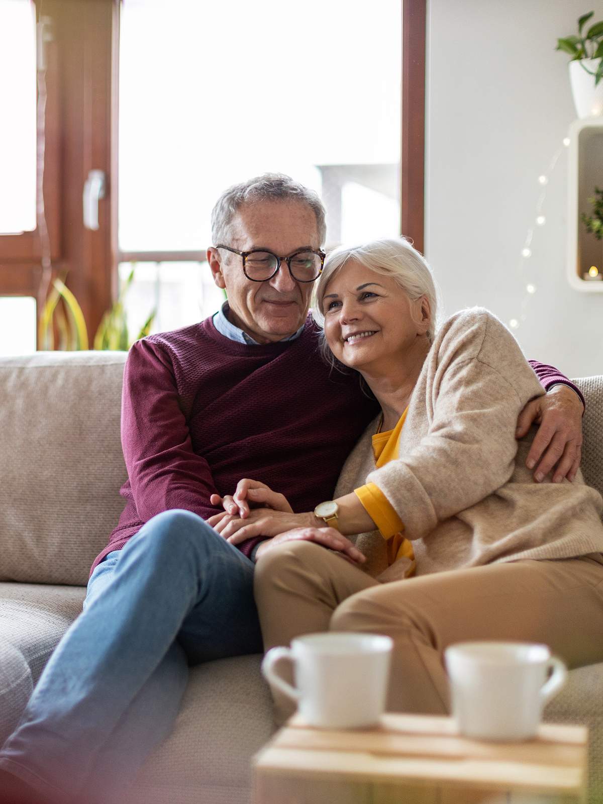 A happy senior couple relax together at home.