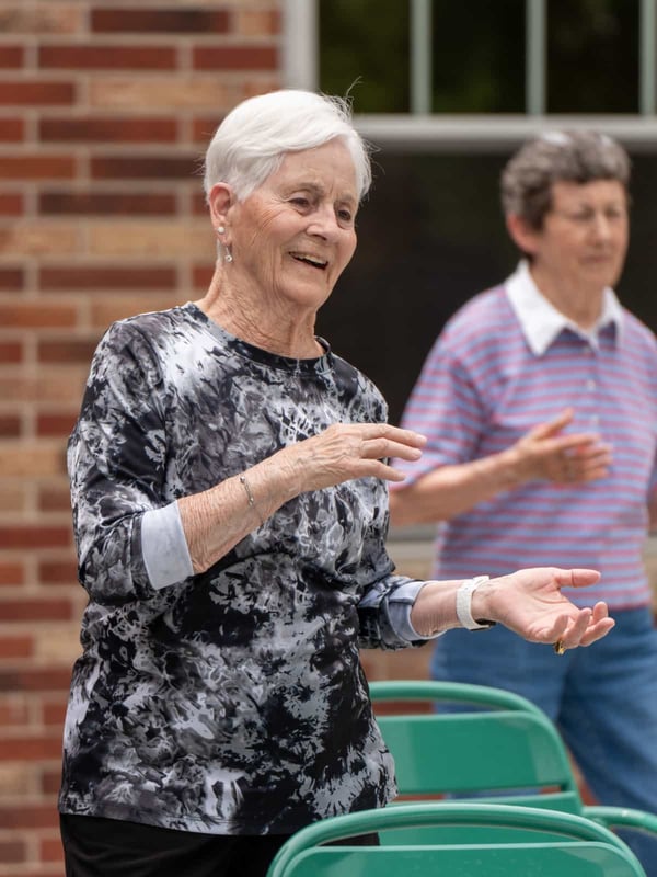 Several residents participate in a Zumba workout on the Patio at Lakeside