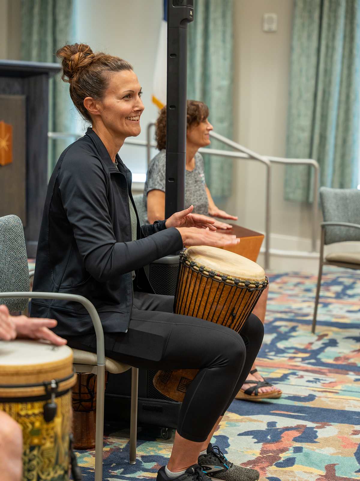 An Immanuel life enrichment coordinator plays the hand drums.
