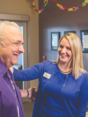 An Immanuel Pathways employee greets a PACE® participant. 