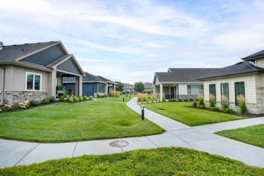 Immanuel instructor supporting elderly woman rock climb.
