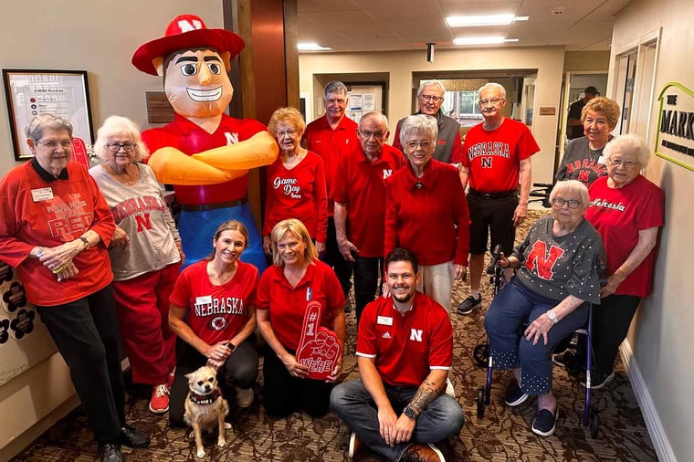 Staff and residents at Arboretum Village celebrate the first Husker football game.