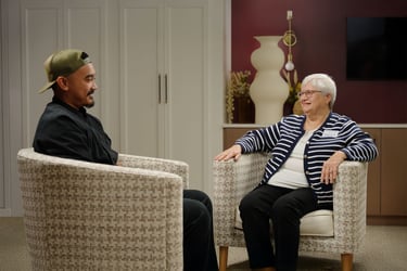 An Immanuel employee talks with a senior living resident.