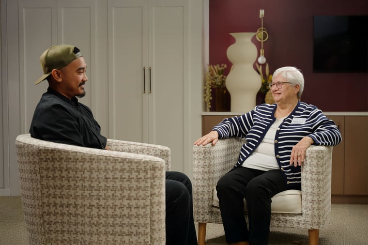 An Immanuel employee talks with a senior living resident.