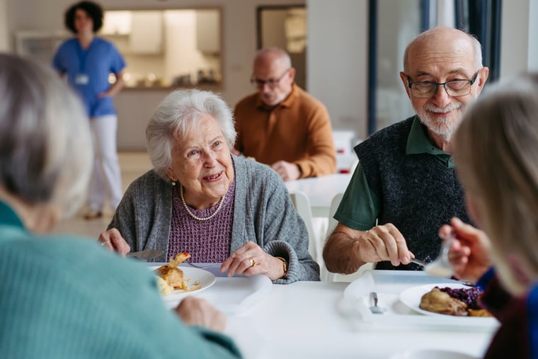 Senior couple having lunch with friends.