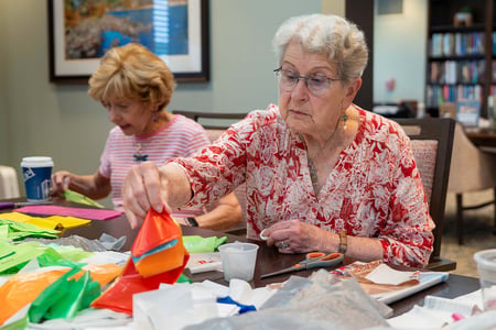 Residents at Pacific Springs in Omaha transform recycled plastic bags into lightweight sleeping mats for people experiencing homelessness.