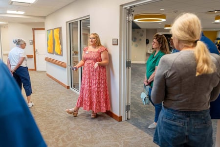 Eve Buettner, Social Services Supervisor at The Lighthouse in Omaha, leads a tour of the long-term care community.