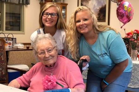 Two women with a long-term care resident.