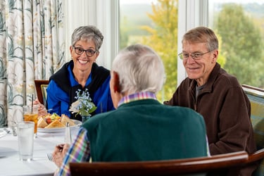 A group of seniors socialize over a meal.
