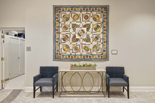 Phoebe Toalson's quilt, titled Circle in the Sun, is on permanent display in The Landing's lower lobby.