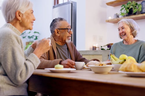A group of seniors have coffee and discuss retirement.