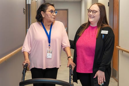 Raeanna Atkins, right, walks with Vera Campos, left, is a PACE® participant at Immanuel Pathways of Eastern Nebraska.