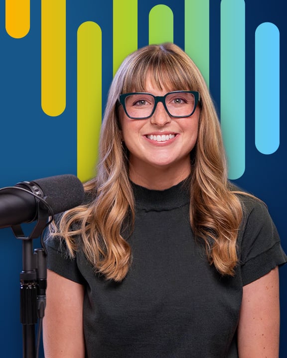 Holly McDonald smiling next to a micriphone