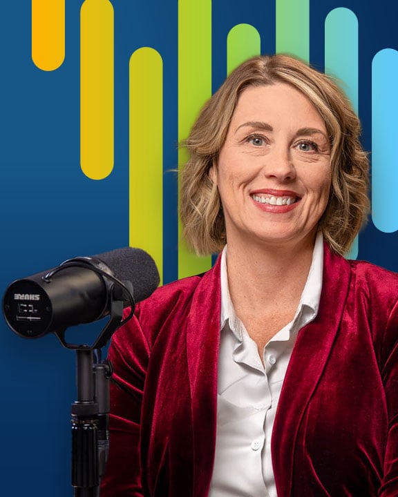 Jeanie Barber smiling next to a microphone