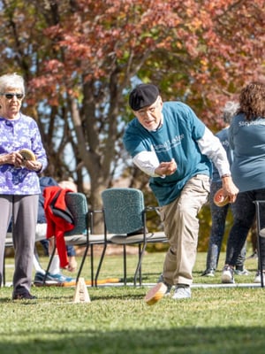 Two seniors play a game of rollers.