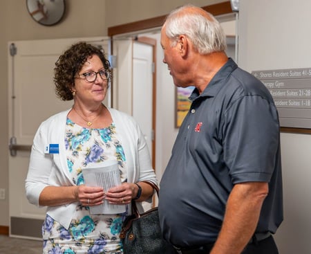 Julie Kaminski, Immanuel Chief Operating Officer, talks with a guest at The Lighthouse.