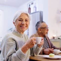 A group of seniors have coffee and discuss retirement.