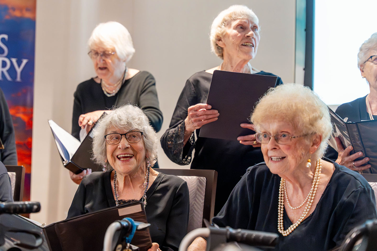 A group of senior women sing.