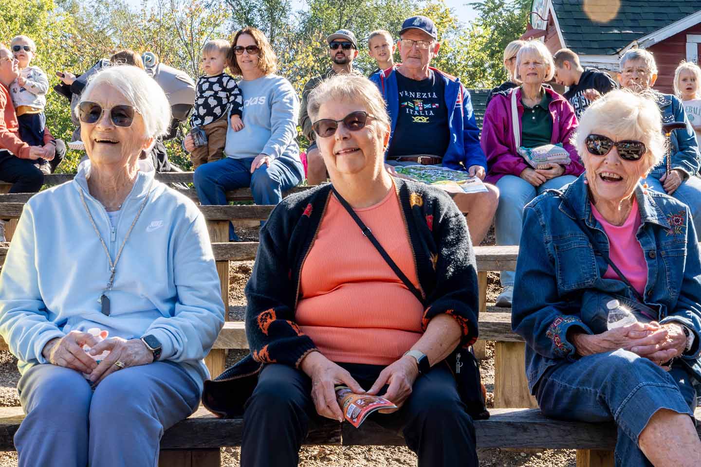 Three senior women watching a performance